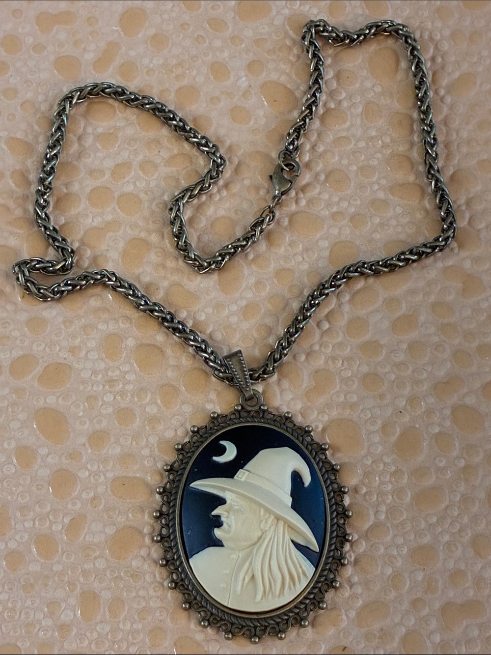 Oval witch black and ivory pendant necklace in brass tone setting